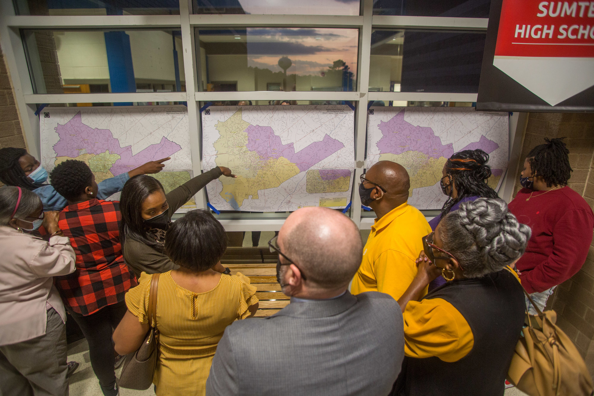 Members of the general public discuss school rezoning options at an information session on Feb. 24, 2022.