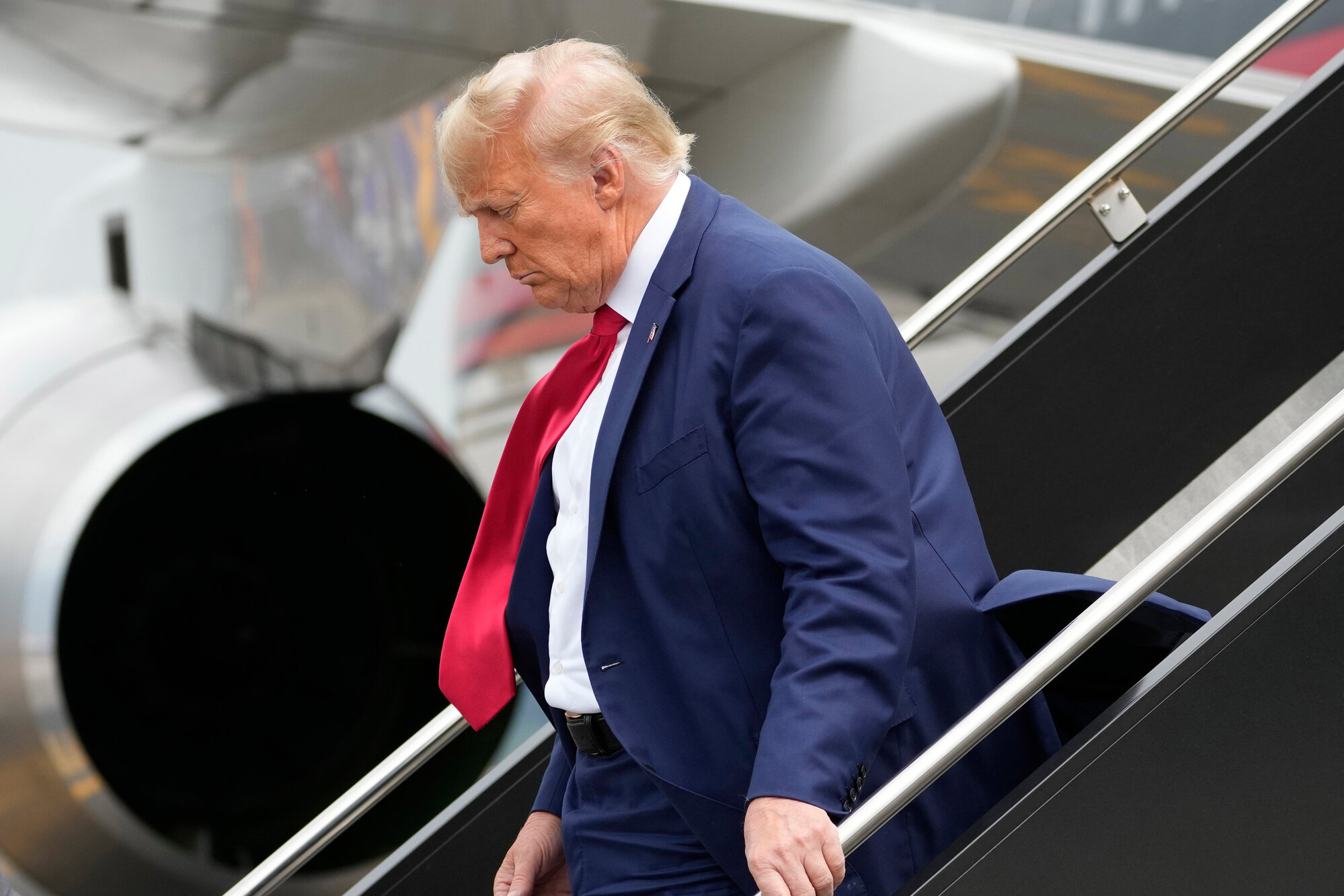 Former President Donald Trump arrives at Ronald Reagan Washington National Airport, Thursday, Aug. 3, 2023, in Arlington, Va., as he headed to Washington to face a judge on federal conspiracy charges alleging Trump conspired to subvert the 2020 election. Trump pleaded not guilty.