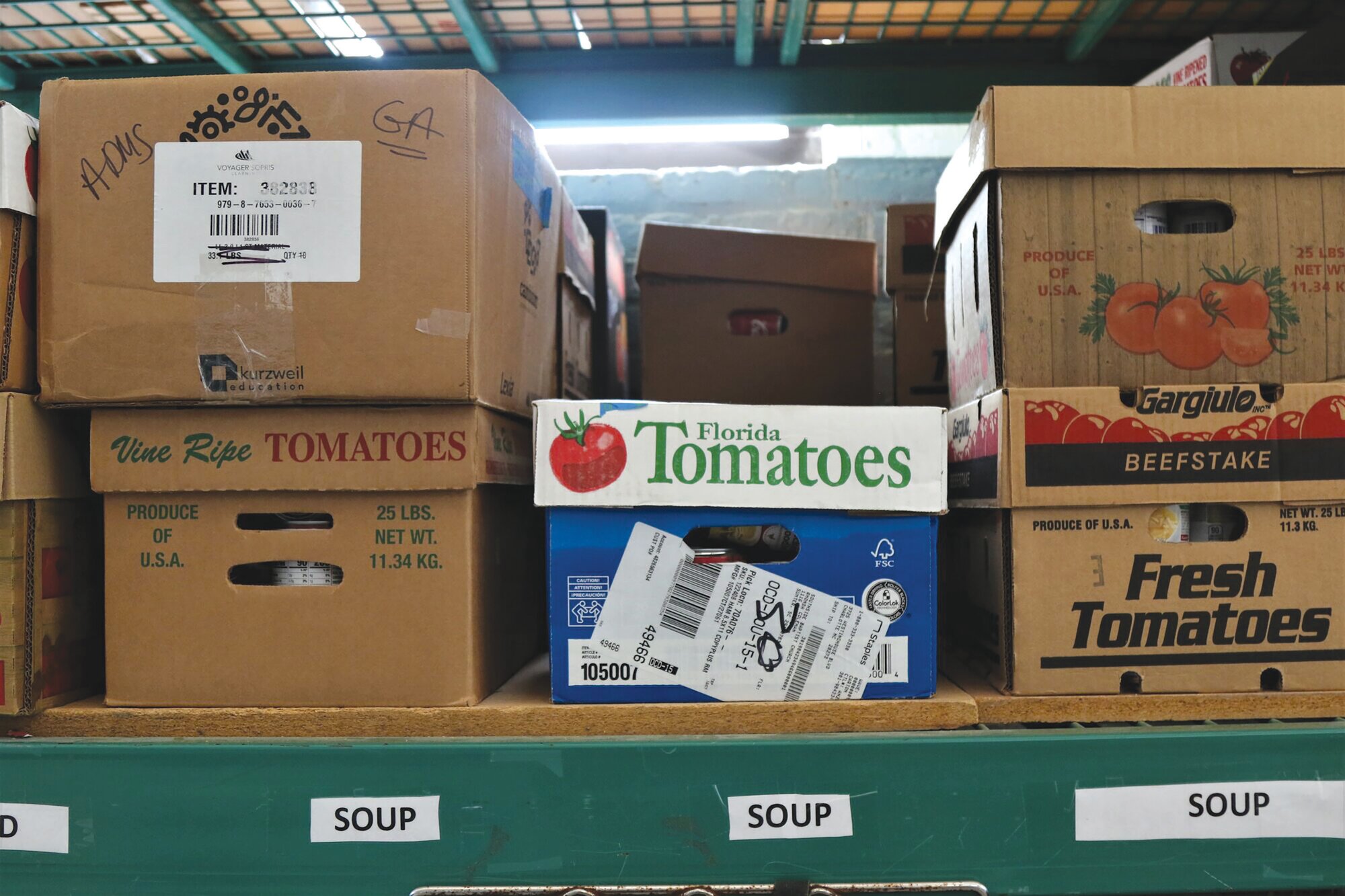 Boxes of donated food items are stacked on shelves at Sumter United Ministries recently.
