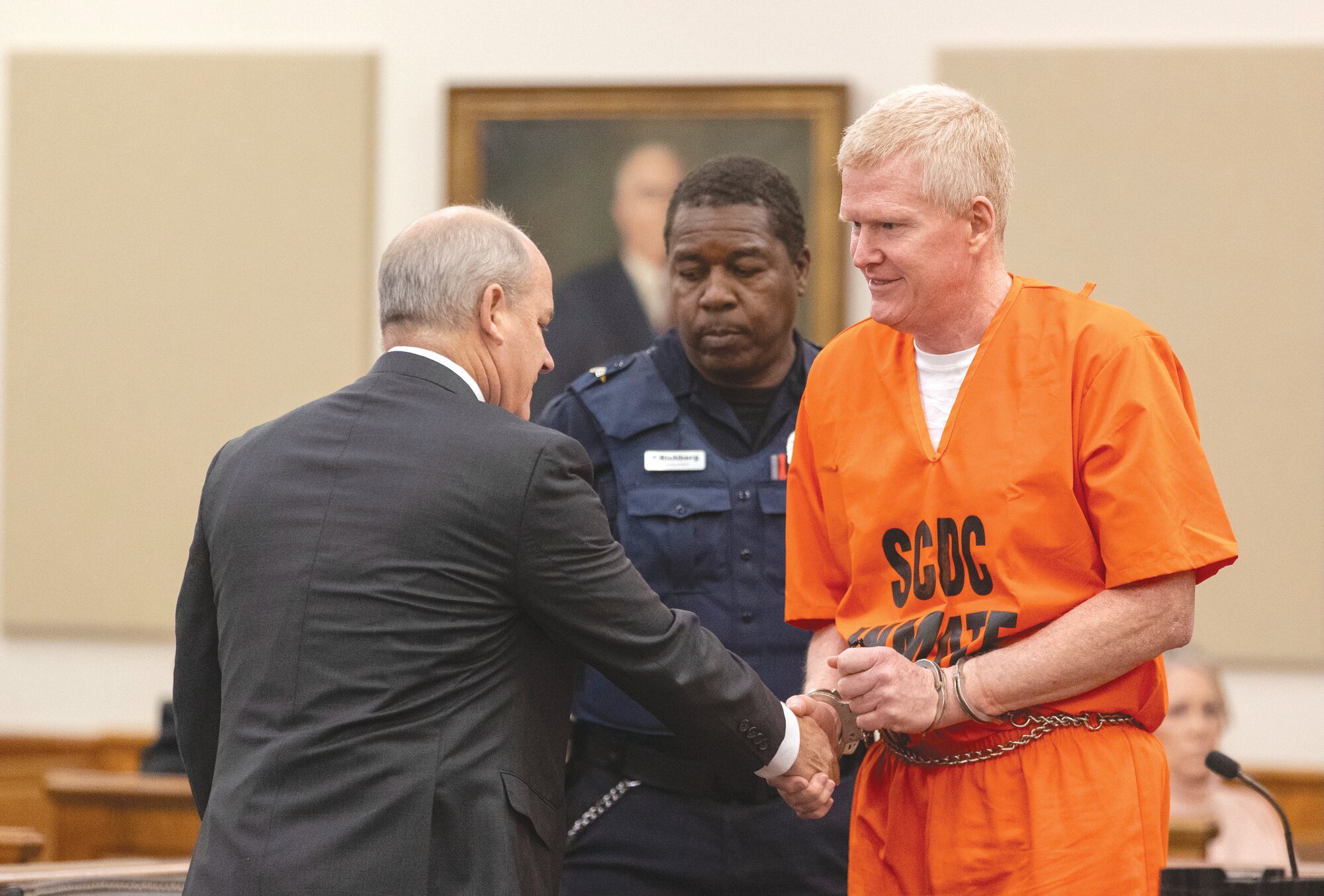 Alex Murdaugh shakes hands with his attorney Jim Griffin during his sentencing for stealing from 18 clients on Tuesday, Nov. 28, at the Beaufort County Courthouse in Beaufort.